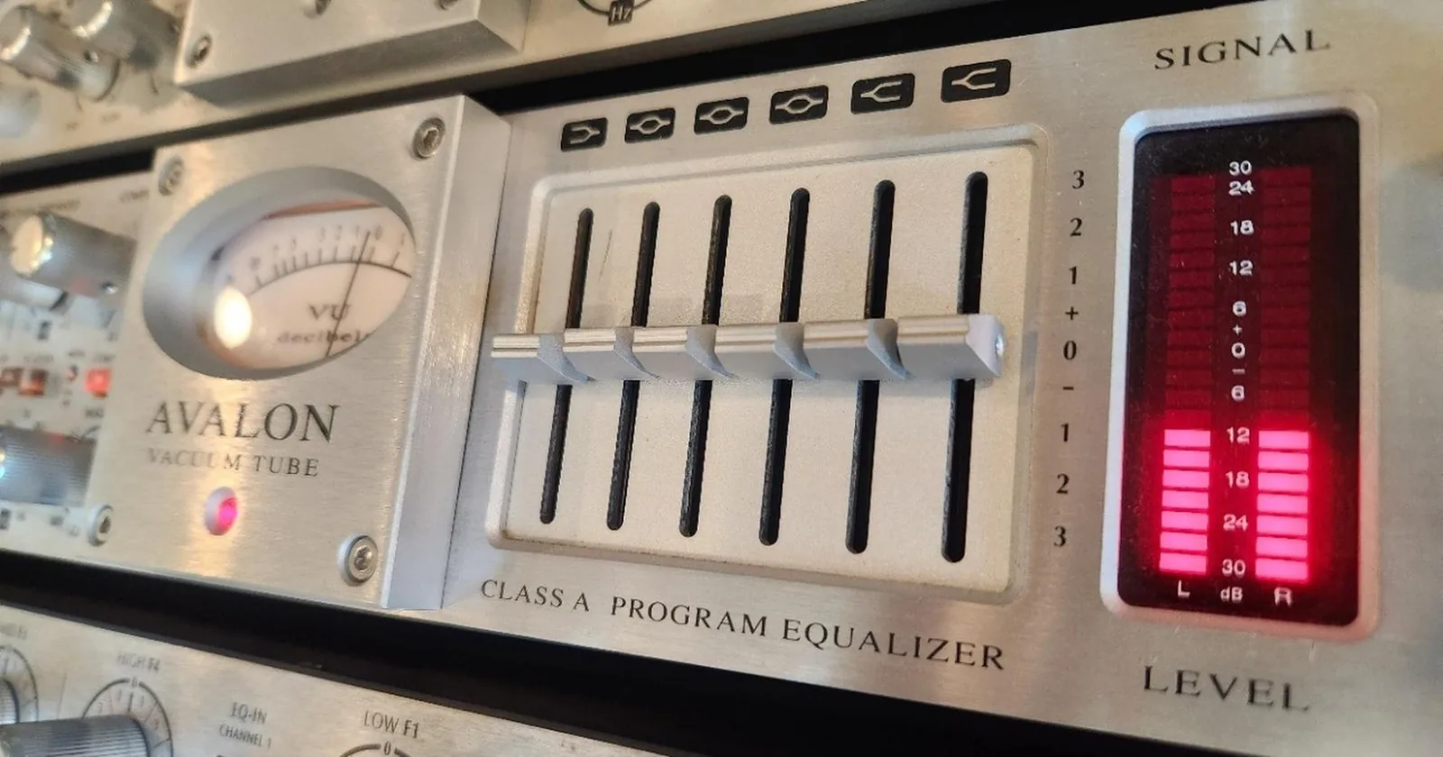 Photo of the Avalon 747sp hardware unit showing six vertical faders for a passive graphic EQ section with fixed frequency bands.