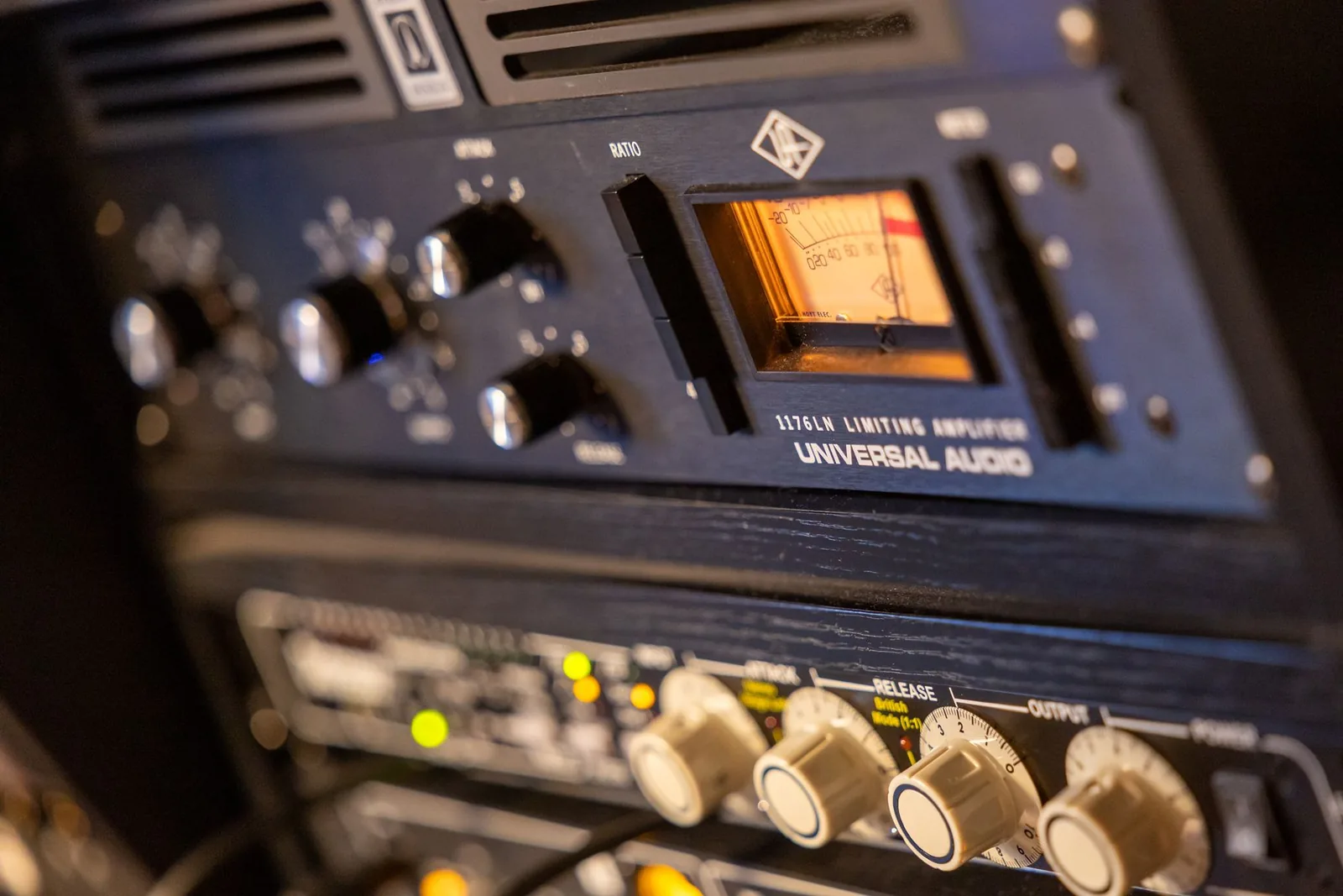 Photo of a Universal Audio 1176LN hardware FET compressor unit with its front panel showing input, output, attack, release, and ratio buttons.