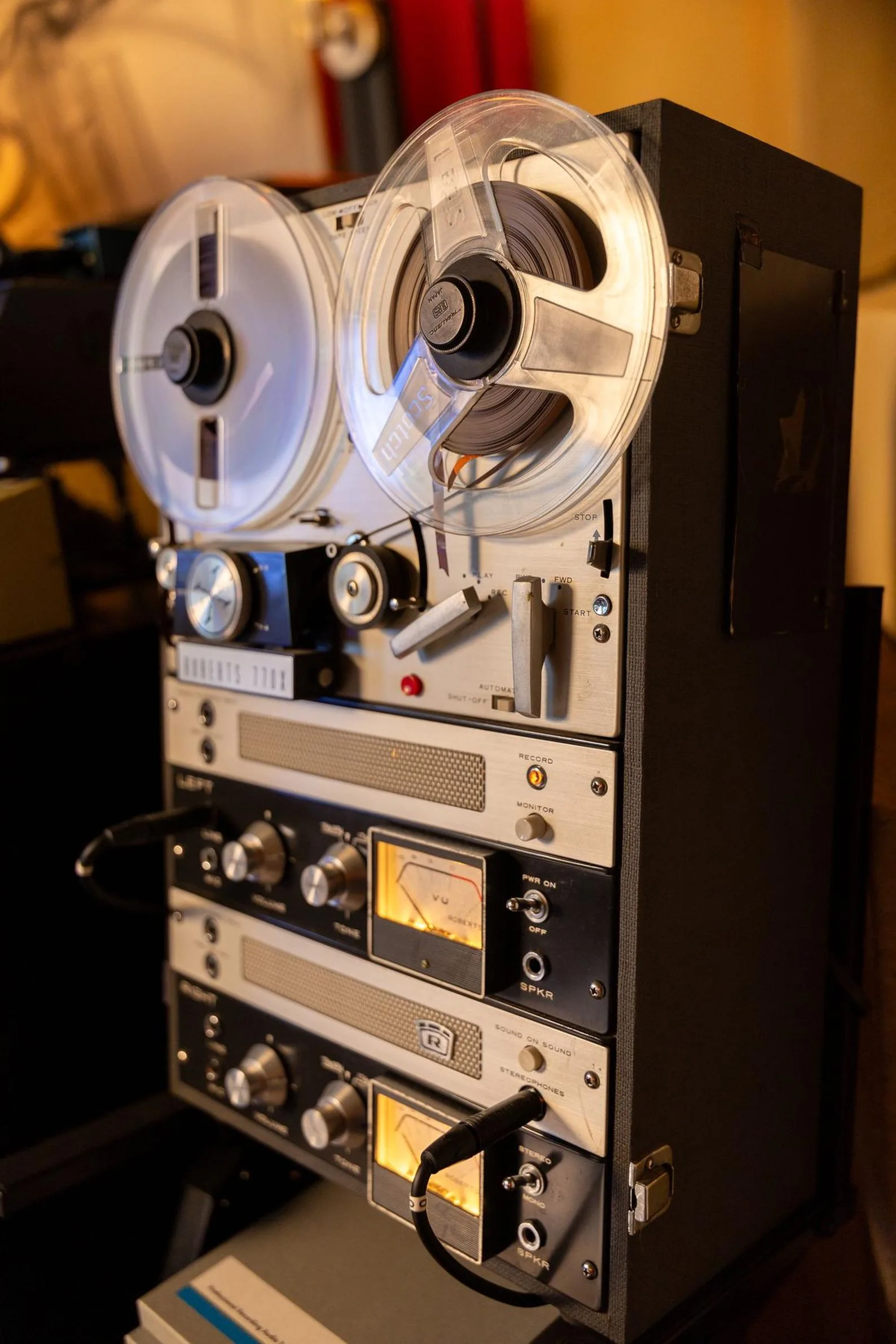 Photo of a professional reel-to-reel analog tape machine with large tape reels mounted on the transport deck.